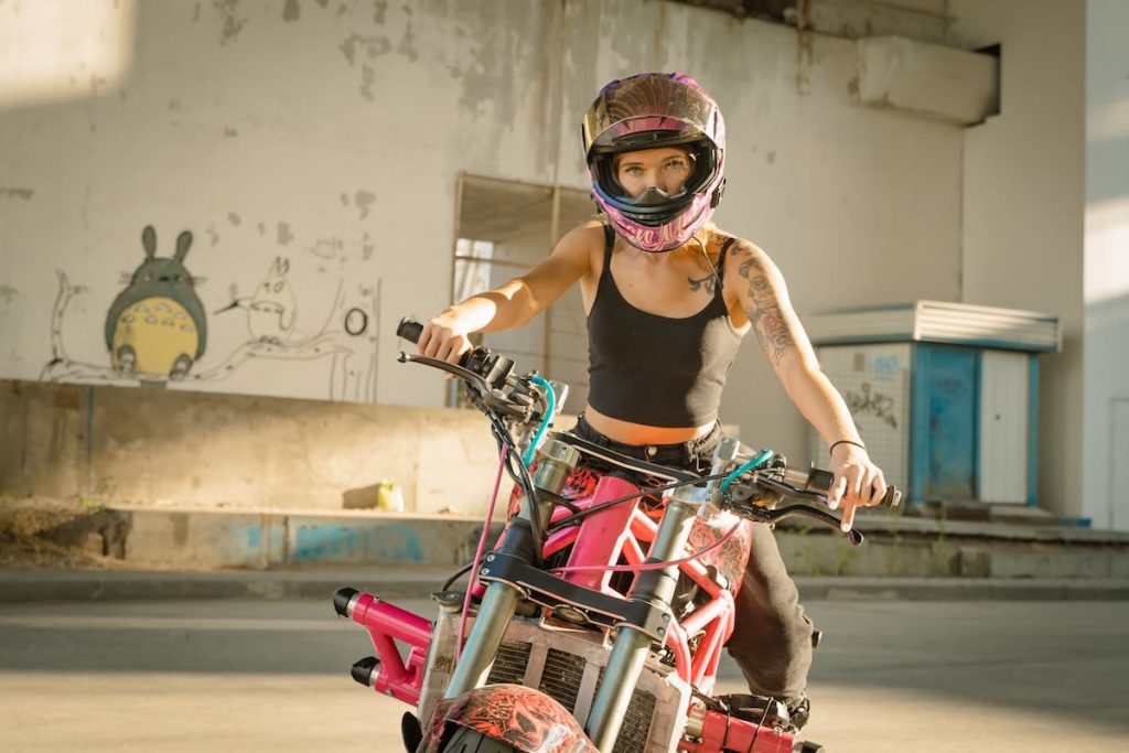 Woman in tank top on a motorbike 